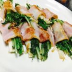 Enoki mushroom and mustard greens wrapped by cooked bacon