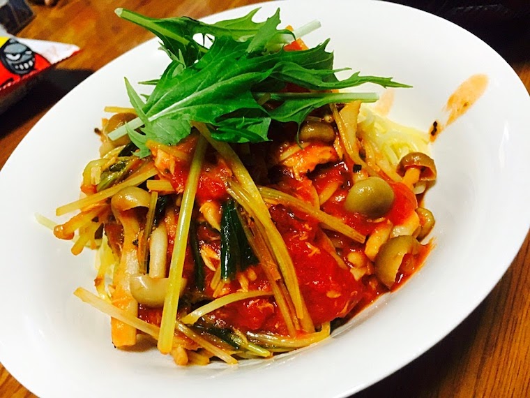 Pasta with tomato sauce with various mushrooms and mustard green