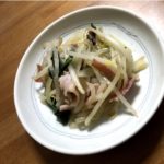 Bacon, bean sprouts, and spinach stir fry on a plate