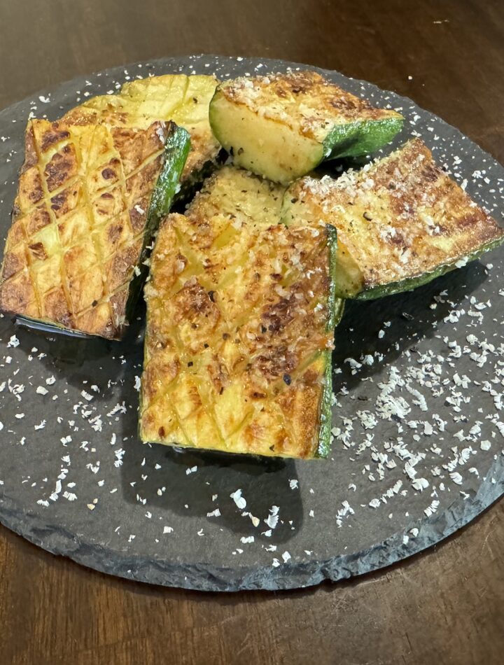 Grilled Zucchini Steak on Black Plate